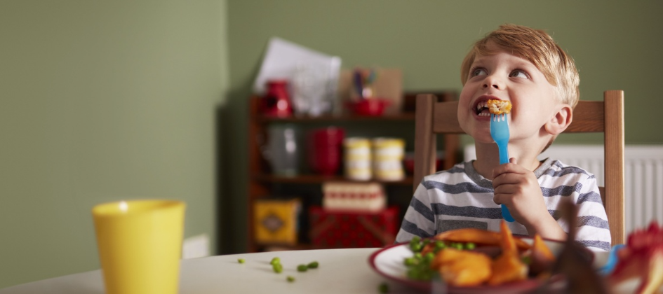 A young boy is tucking into a healthy meal from Tesco