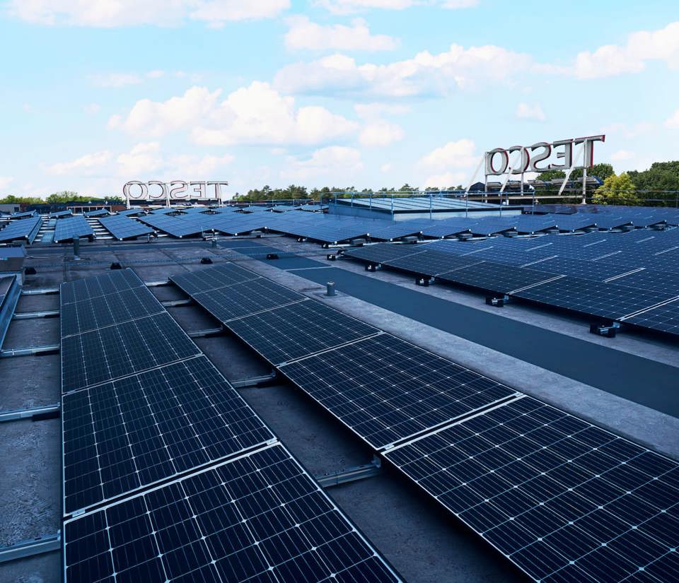 A wide view of solar panels on the roof of a Tesco store
