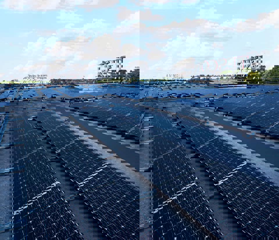 A wide view of solar panels on the roof of a Tesco store