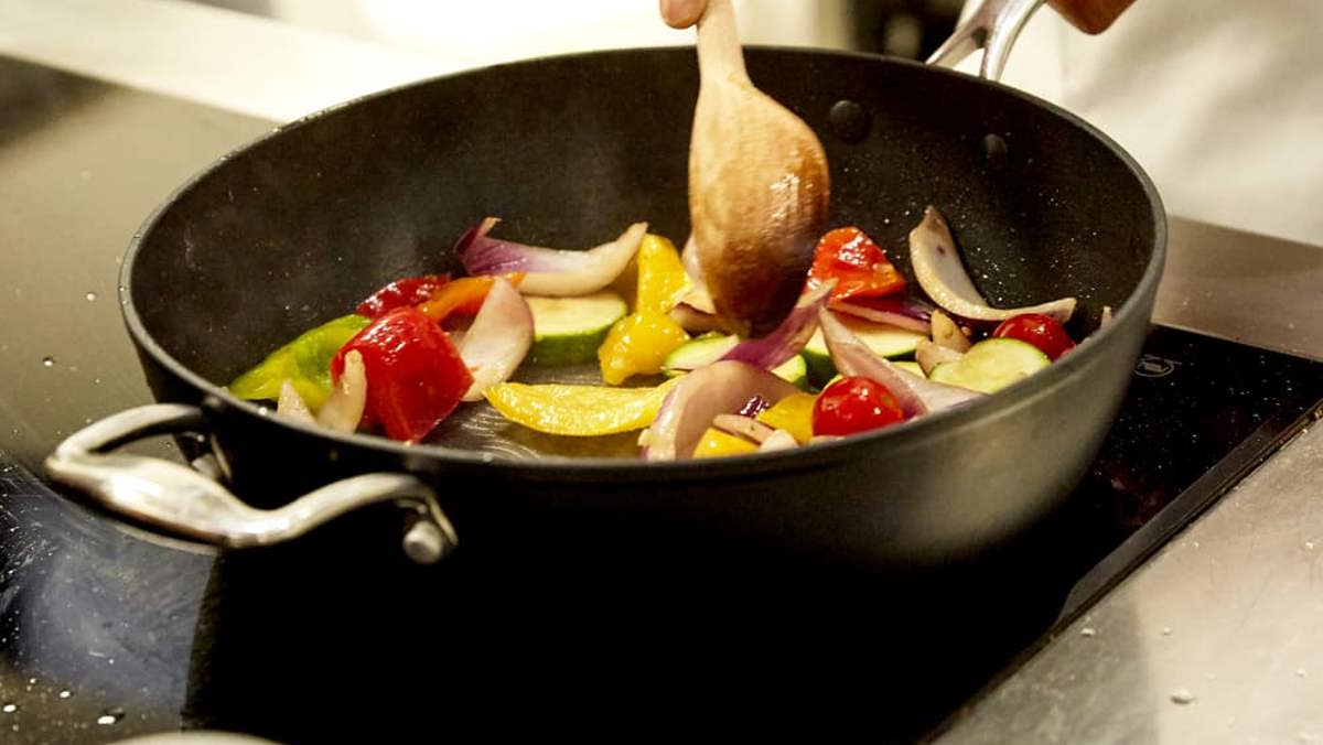 Close up of stirring a vegetable stir fry in a wok