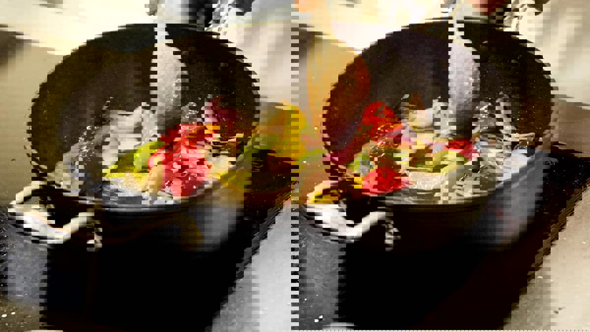 Close up of stirring a vegetable stir fry in a wok