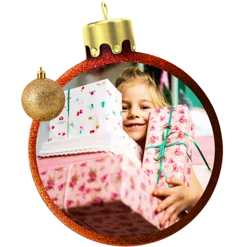 A smiling young girl carrying a pile of wrapped Christmas presents